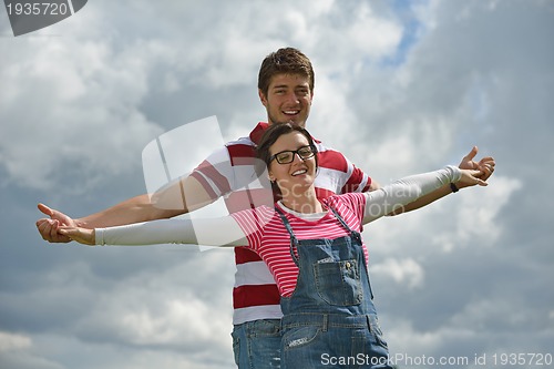 Image of Portrait of romantic young couple smiling together outdoor