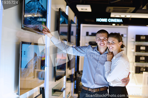 Image of Young couple in consumer electronics store