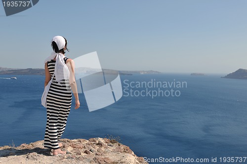 Image of Greek woman on the streets of Oia, Santorini, Greece