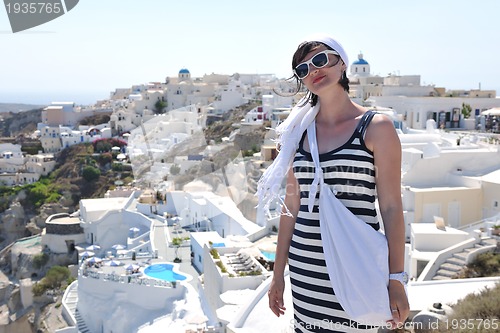 Image of Greek woman on the streets of Oia, Santorini, Greece