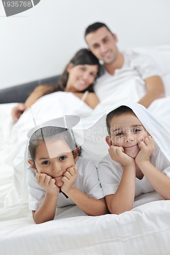 Image of happy young Family in their bedroom