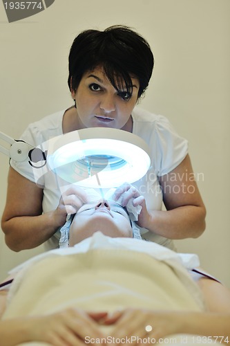 Image of woman with facial mask in cosmetic studio