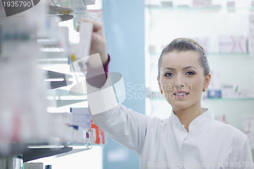 Image of pharmacist chemist woman standing in pharmacy drugstore