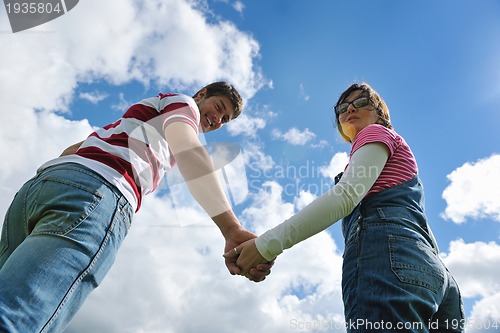 Image of Portrait of romantic young couple smiling together outdoor