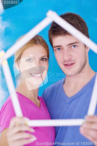 Image of happy couple paint wall at new home