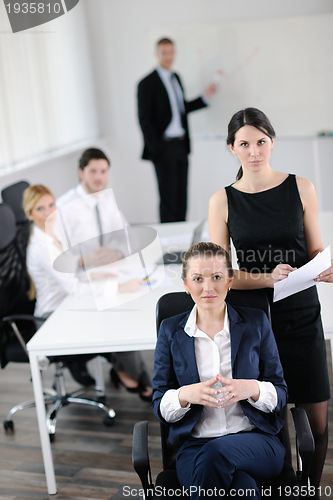 Image of business woman with her staff in background