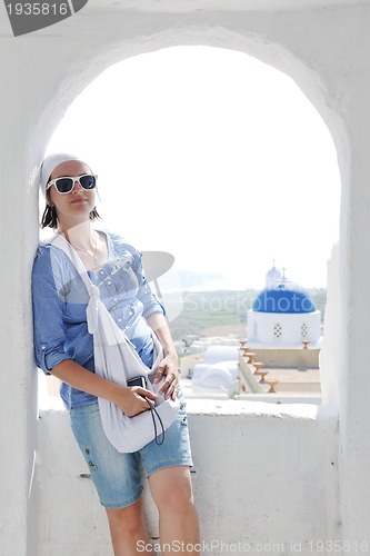 Image of Greek woman on the streets of Oia, Santorini, Greece