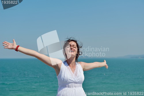 Image of happy young woman with spreading arms to sky