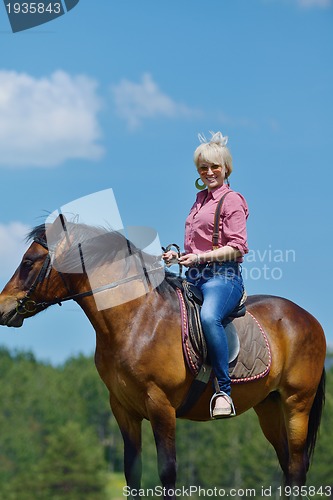 Image of happy woman  on  horse