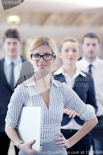 Image of business woman standing with her staff at conference