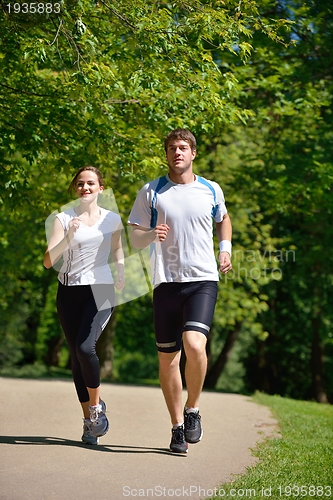 Image of Young couple jogging at morning