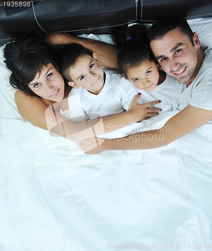 Image of happy young Family in their bedroom