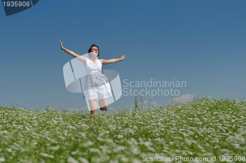 Image of Young happy woman in green field