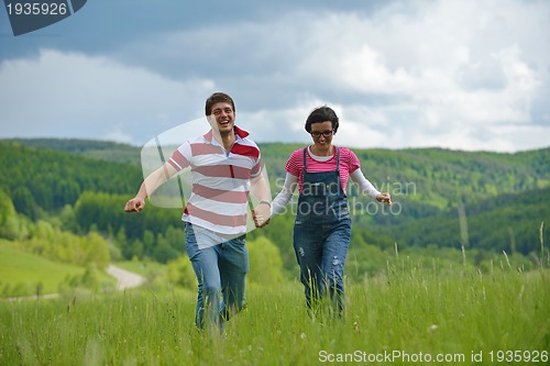 Image of Portrait of romantic young couple smiling together outdoor