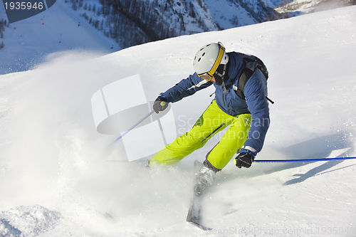 Image of skiing on fresh snow at winter season at beautiful sunny day