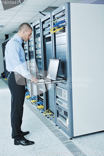 Image of young it engineer in datacenter server room