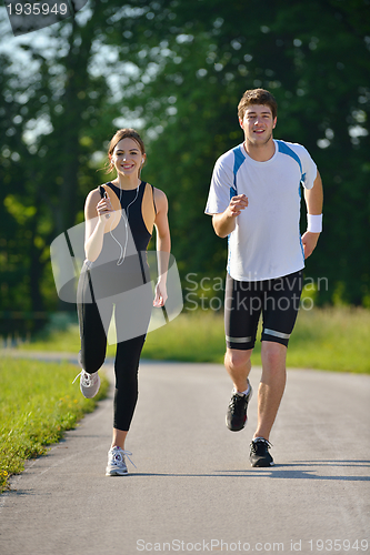 Image of Young couple jogging at morning