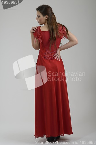 Image of elegant woman in fashionable dress posing in the studio