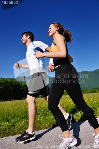 Image of Young couple jogging