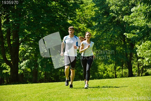 Image of Young couple jogging at morning