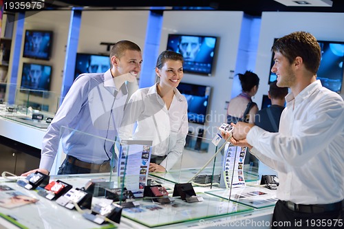 Image of Young couple in consumer electronics store