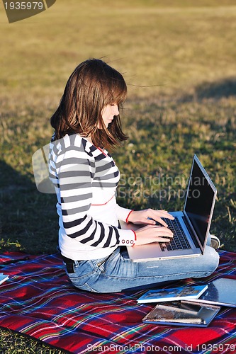 Image of young teen girl work on laptop outdoor