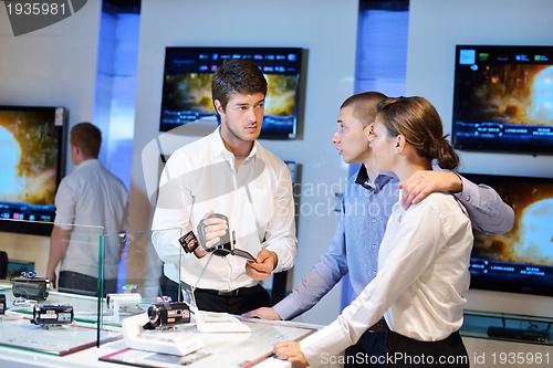 Image of Young couple in consumer electronics store