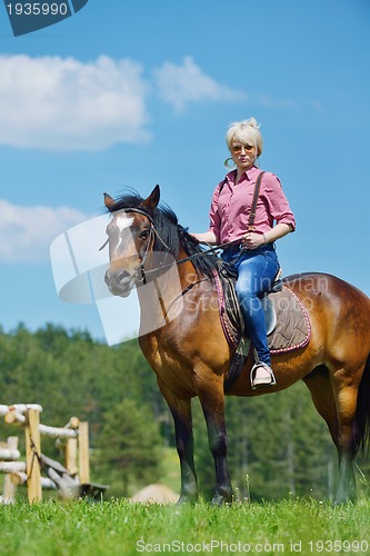 Image of happy woman  ride  horse