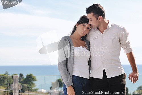 Image of couple relaxing on balcony