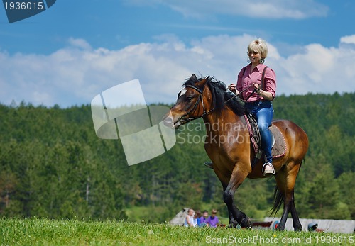 Image of happy woman  on  horse