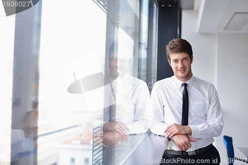 Image of business man  on a meeting in offce with colleagues in backgroun