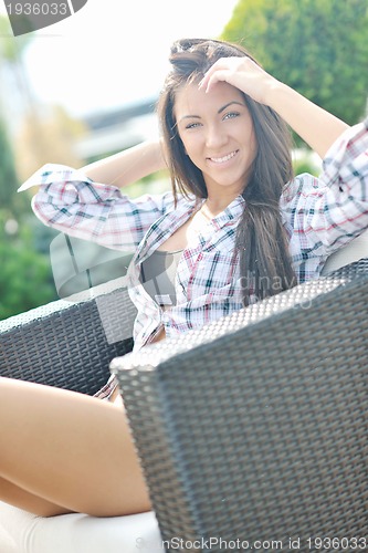 Image of beautiful young lady posing in garden