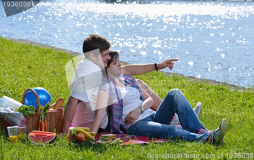 Image of happy young couple having a picnic outdoor
