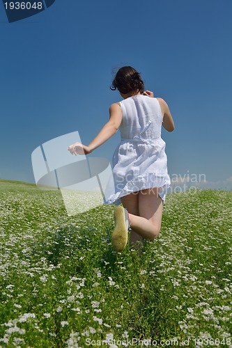 Image of Young happy woman in green field