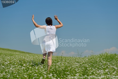 Image of Young happy woman in green field
