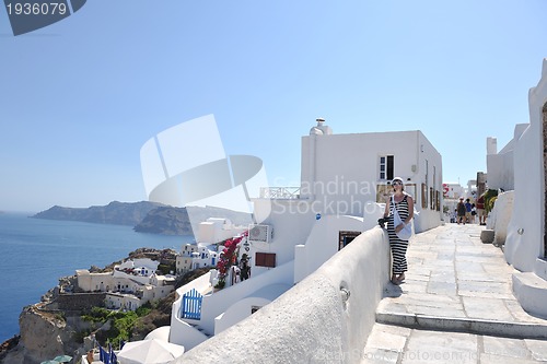 Image of Greek woman on the streets of Oia, Santorini, Greece