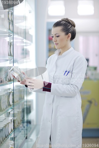 Image of pharmacist chemist woman standing in pharmacy drugstore