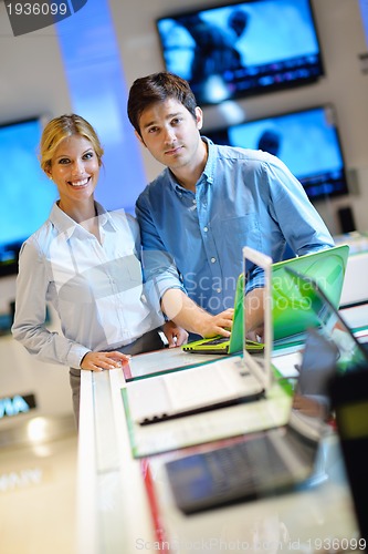 Image of Young couple in consumer electronics store