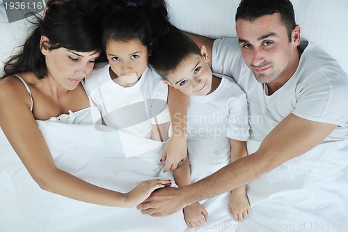 Image of happy young Family in their bedroom