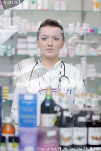 Image of pharmacist chemist woman standing in pharmacy drugstore