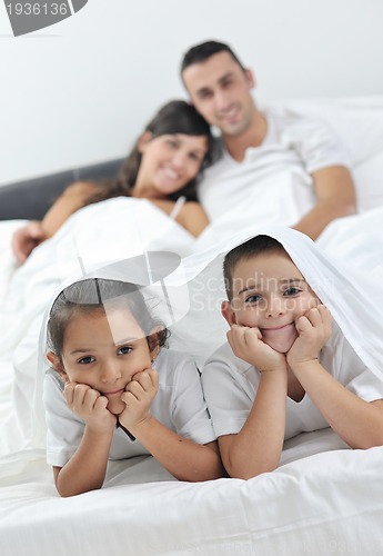 Image of happy young Family in their bedroom