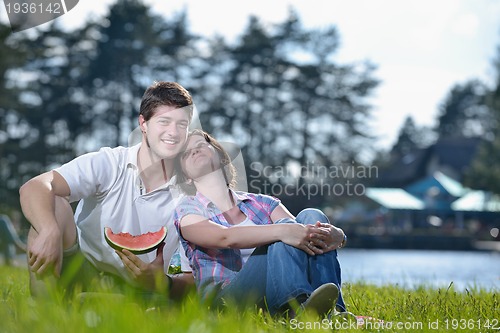 Image of happy young couple having a picnic outdoor