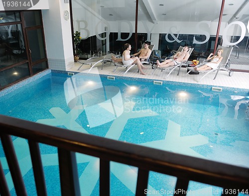 Image of young people group at spa swimming pool