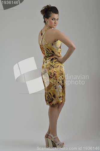 Image of elegant woman in fashionable dress posing in the studio