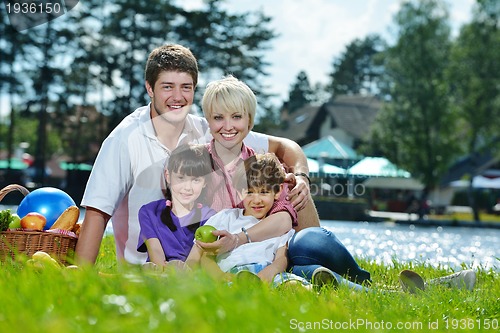 Image of Happy family playing together in a picnic outdoors