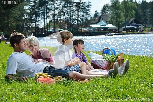 Image of Happy family playing together in a picnic outdoors