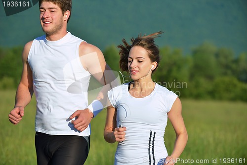 Image of Young couple jogging at morning