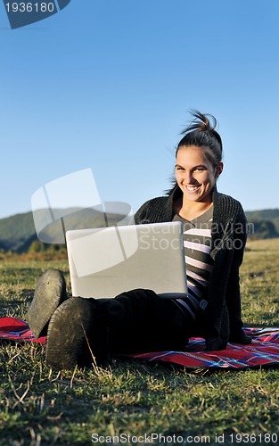 Image of young teen girl work on laptop outdoor