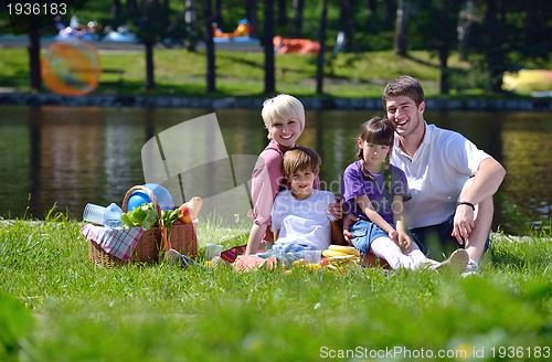 Image of Happy family playing together in a picnic outdoors