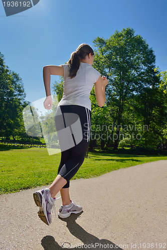 Image of Young beautiful  woman jogging